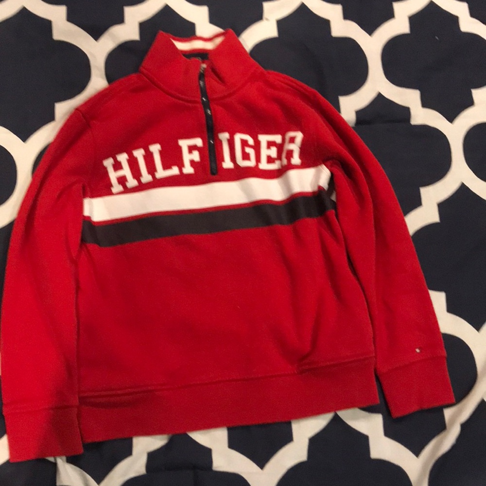 It is a tommy sweatshirt and it says hilfiger